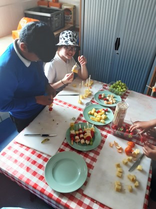 Making fruit kebabs 